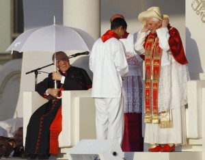 Archbishop of Madrid Rouco Varela laughs as Pope Benedict XVI puts on a hat during a welcoming celebration in central Madrid